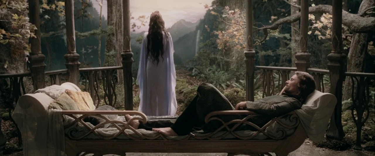 The Lord of The Rings: The Two Towers (2002) movie still: fullbody — An open stone terrace overlooks a distant mountainous landscape with dense…
