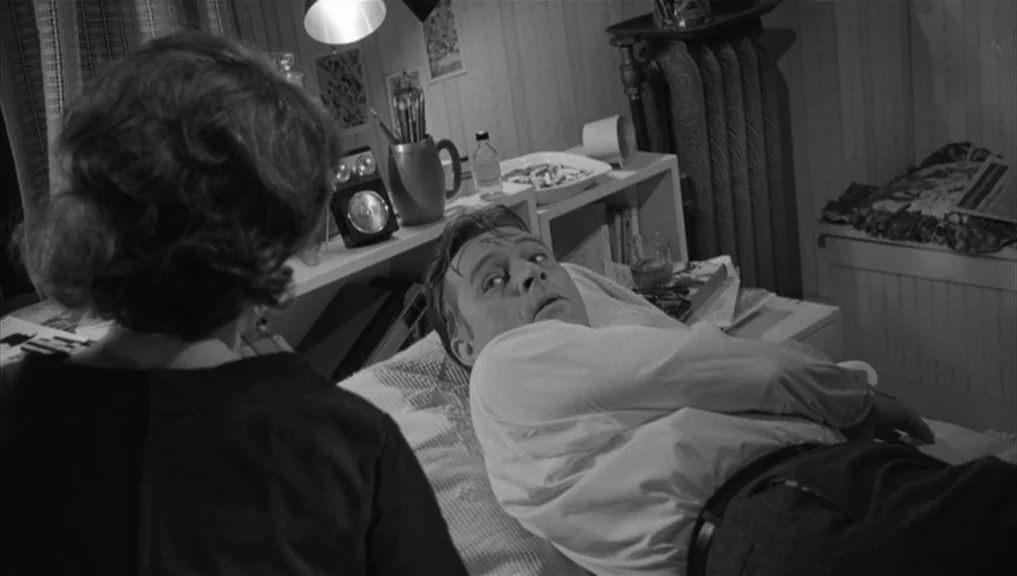 Who’s Afraid Of Virginia Woolf? (1966) movie still: medium — A small room features a bed positioned beneath a shelf with various household objects.…