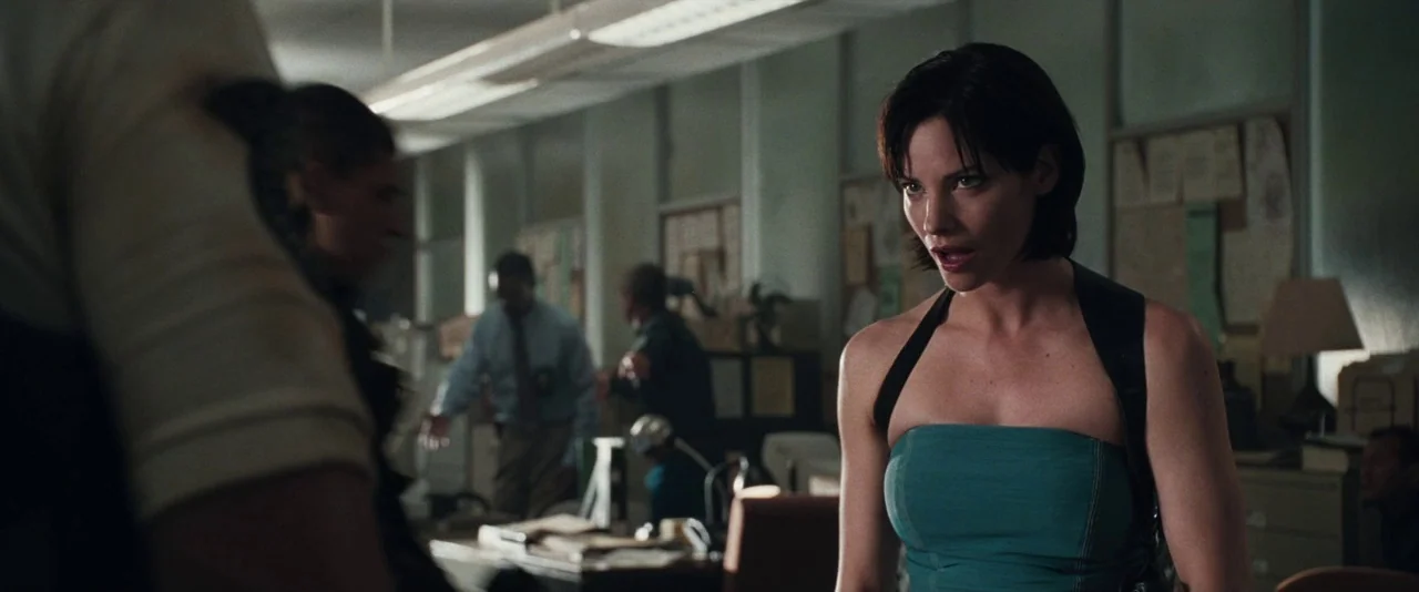 Resident Evil: Apocalypse (2004) movie still: medium — A busy police department interior features rows of desks, cork boards, and filing cabinets. A…