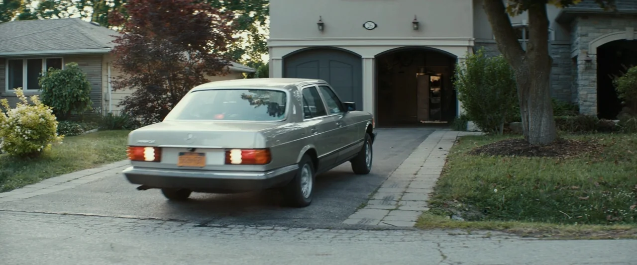 Strange but True (2019) movie still: medium — A suburban residential driveway features a modern two-car garage with stone veneer accents. A silver…