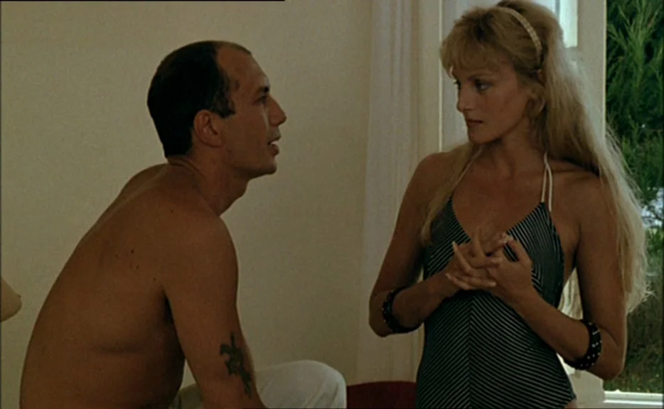 Pauline At the Beach (Pauline à la plage) (1983) movie still: medium — An interior bedroom with plain beige walls and a window revealing green…