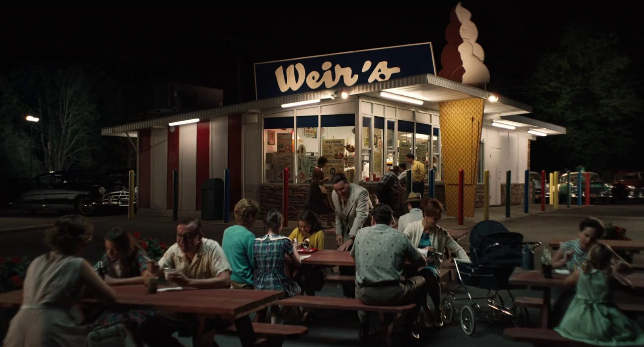 The Irishman (2019) movie still: wide — A 1950s style ice cream stand features a large model cone on the roof. Patrons sit at wooden picnic tables…