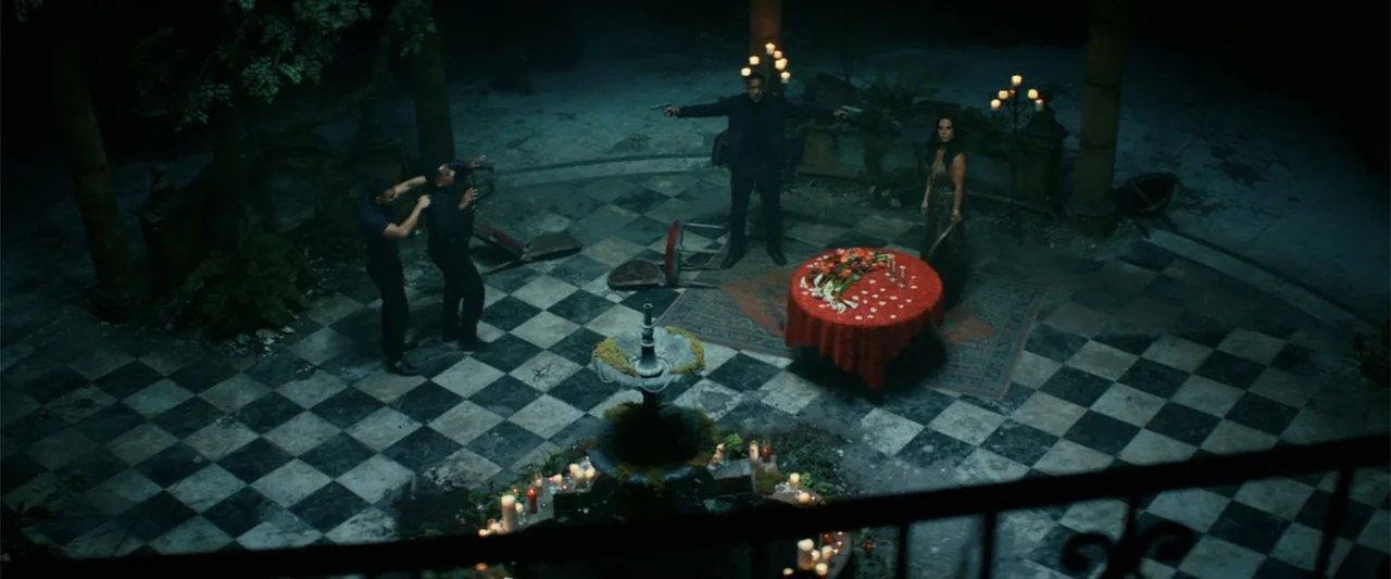 Bad Boys for Life (2020) movie still: wide — A dark stone courtyard features a black and white checkerboard floor and a central fountain. A small…