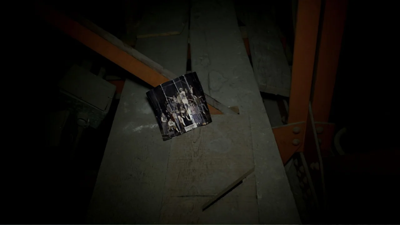 The Gallows (2015) movie still: closeup — A dark attic contains a wooden structure with orange support beams and dusty surfaces. A small group…