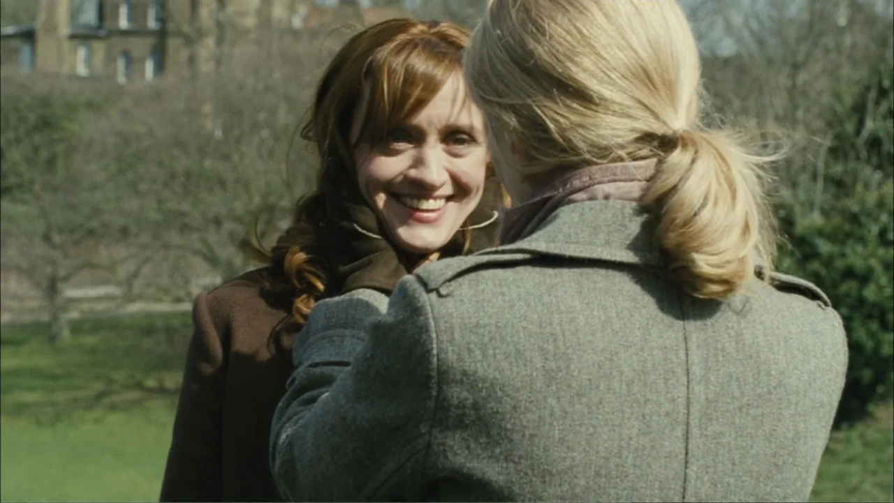 Before I Go to Sleep (2014) movie still: medium — An outdoor park setting with bare winter trees in the background. One woman stands facing another…