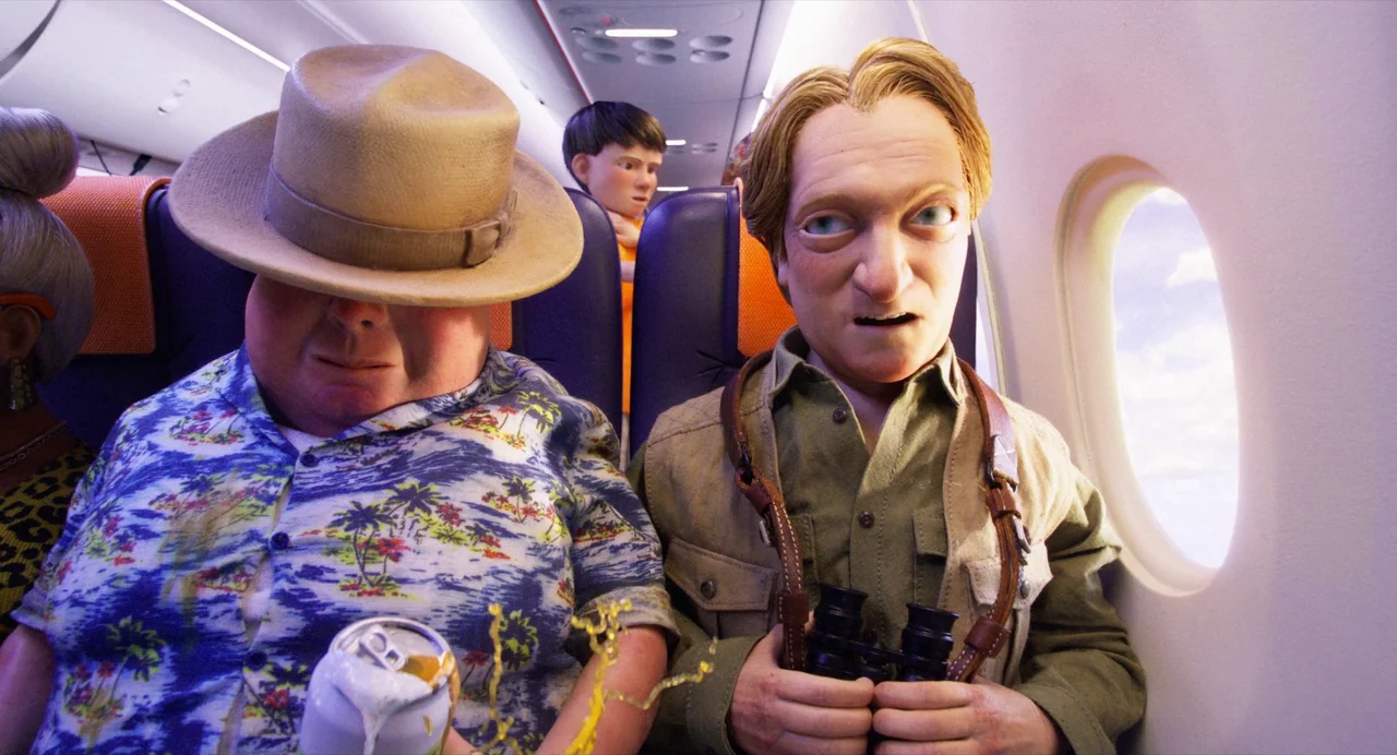 Beetlejuice Beetlejuice (2024) movie still: medium — The interior of an airplane cabin shows rows of purple seats under bright light. A man with…