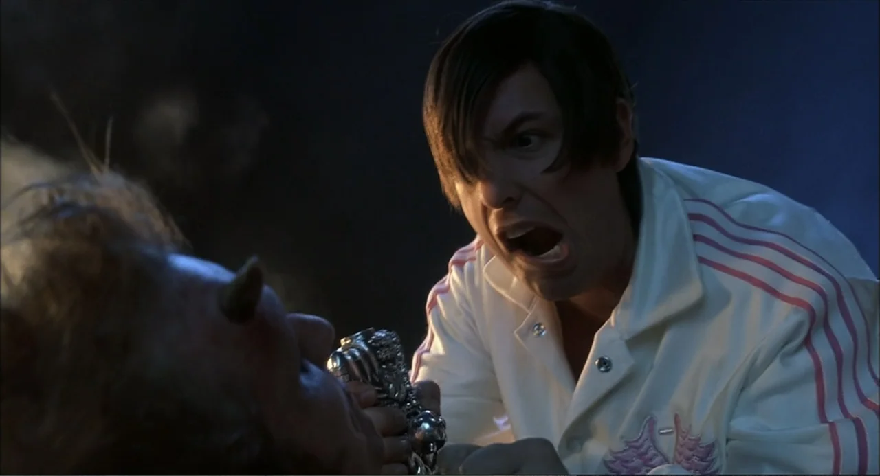 Little Nicky (2000) movie still: medium — A dark indoor space with cool lighting and indistinct architectural features in the background. A man in a…