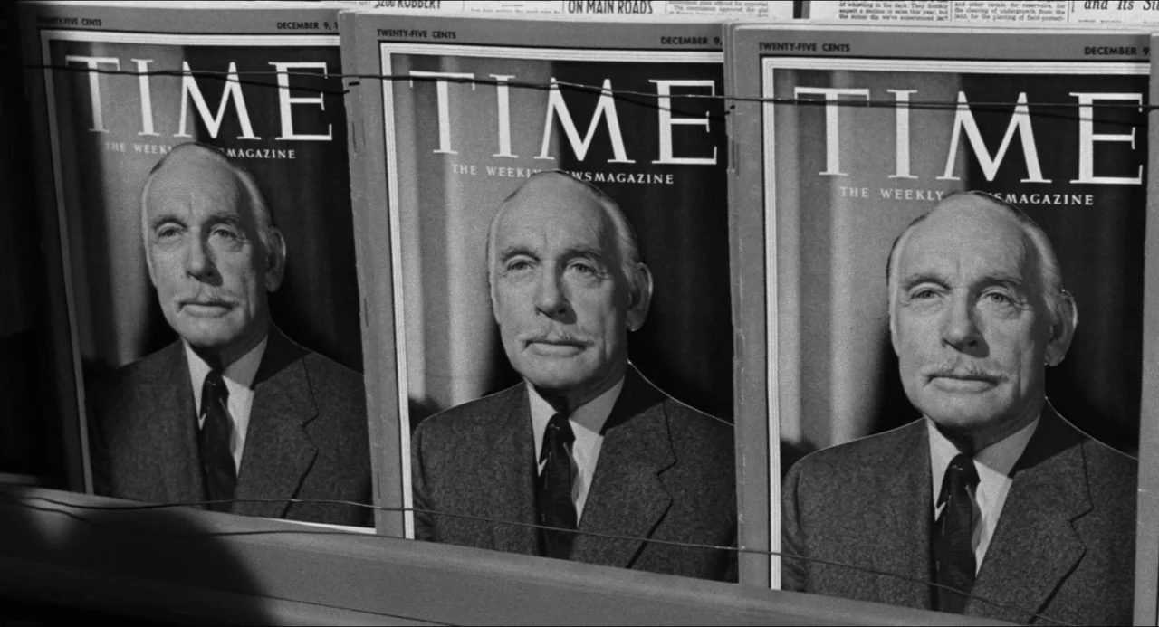 The Fearmakers (1958) movie still: closeup — Three identical copies of Time magazine are lined up horizontally on a display rack. Each magazine…
