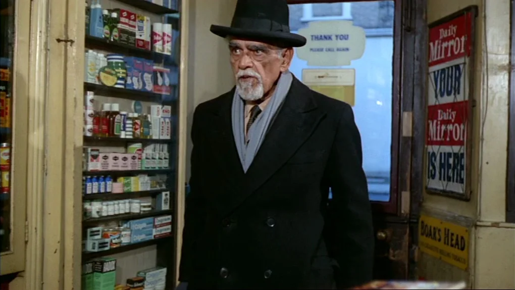 The Sorcerers (1967) movie still: medium — A cramped store interior contains shelves packed with various medicine bottles and toiletries. A man…