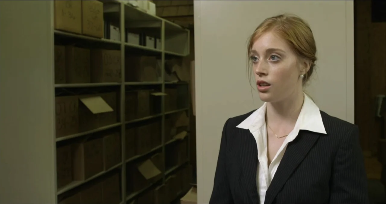 Faith, Love & Chocolate (2018) movie still: medium — A cramped storage room features floor-to-ceiling metal shelving units packed with uniform…