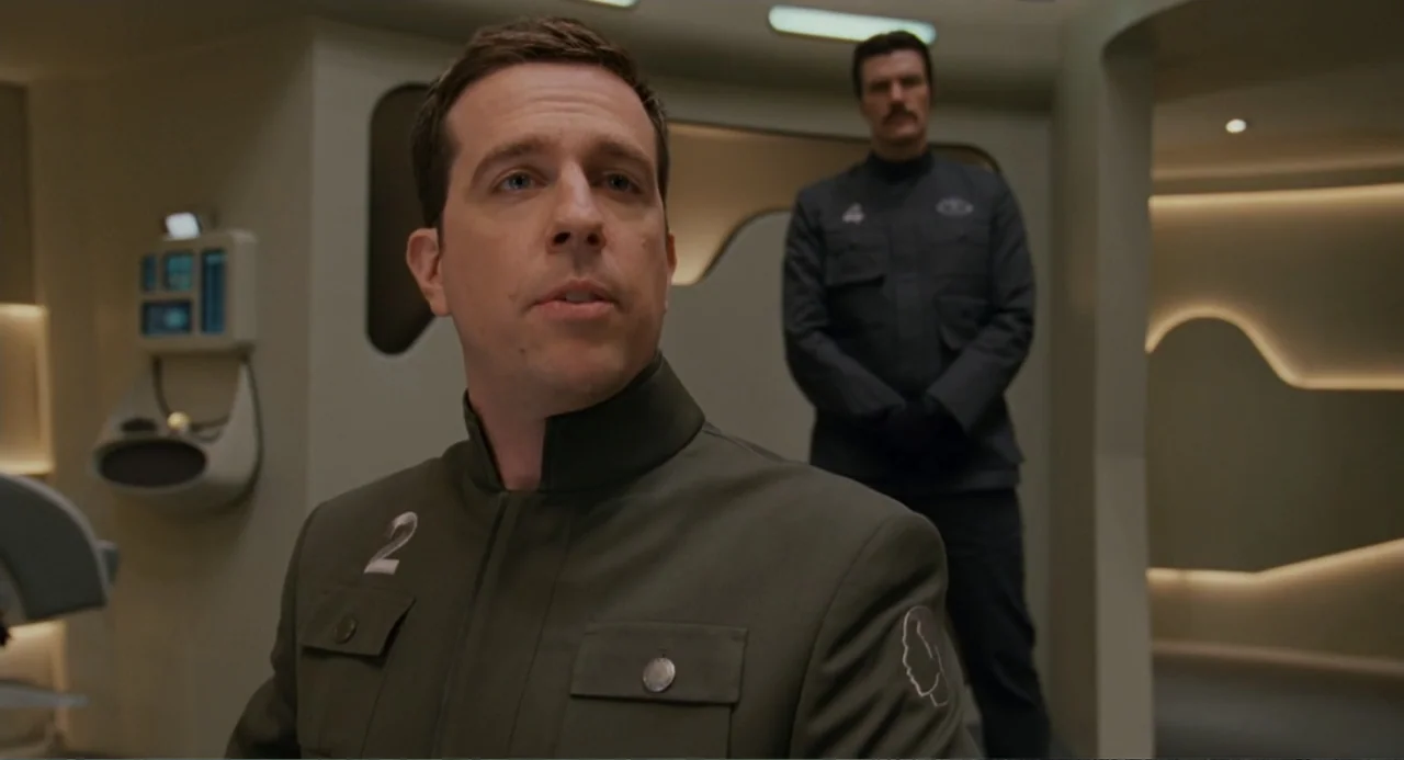 Meet Dave (2008) movie still: medium — A futuristic sterile corridor features curved walls with minimalist recessed lighting and light panels. A man…