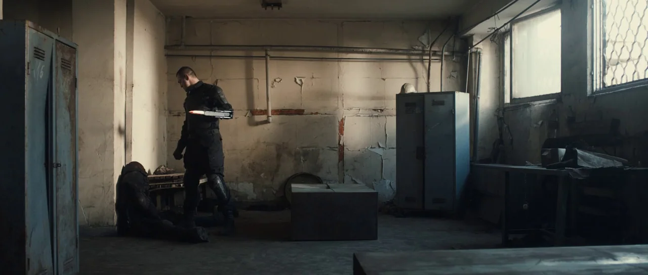 Universal Soldier: Regeneration (2009) movie still: wide — A dilapidated, industrial room features peeling plaster walls, metal lockers, and debris…