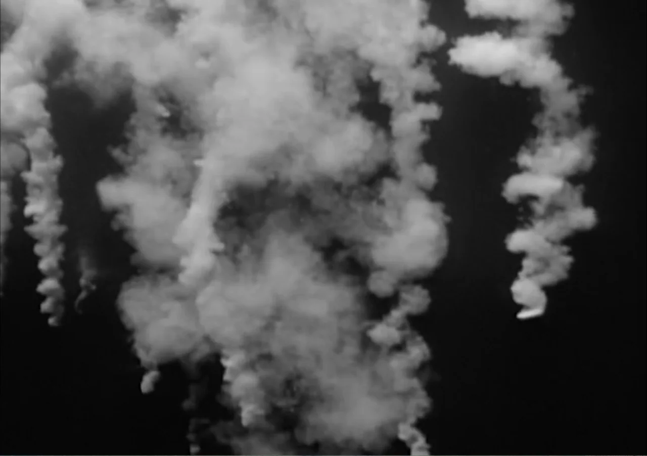 Creature from the Black Lagoon (1954) movie still: establishing — Wispy white smoke trails swirl upward against a pitch black night sky background.…