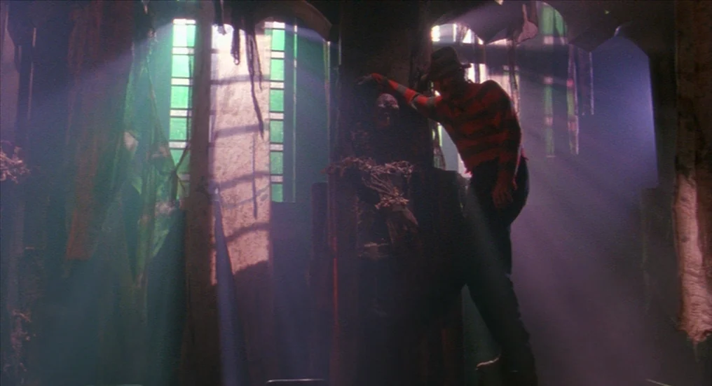 A Nightmare On Elm Street 4: The Dream Master (1988) movie still: fullbody — A dark, dilapidated cathedral interior features tattered green fabric…