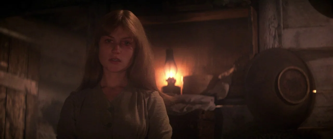 Heaven’s Gate (1980) movie still: medium — A rustic cellar interior features wooden walls and a large bowl in the foreground. A young woman stands…