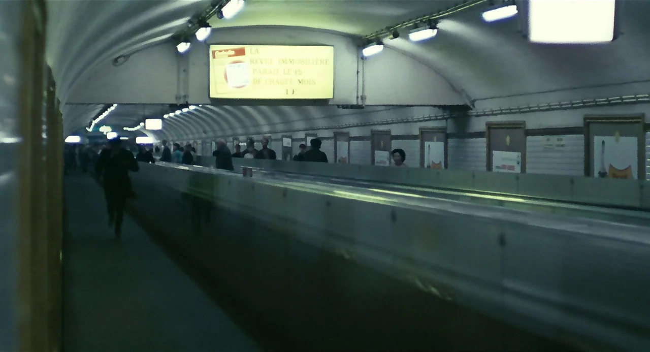 Le Samouraï (1967) movie still: wide — A long, curved Paris Metro subway tunnel features white tile walls and rectangular advertisements. Several…
