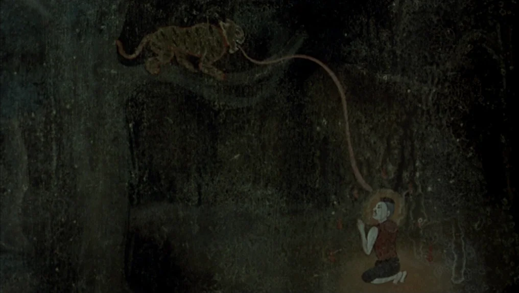 Tropical Malady (2004) movie still: wide — An ancient stone cave wall features a weathered mural painted in dark natural pigments. The painting…