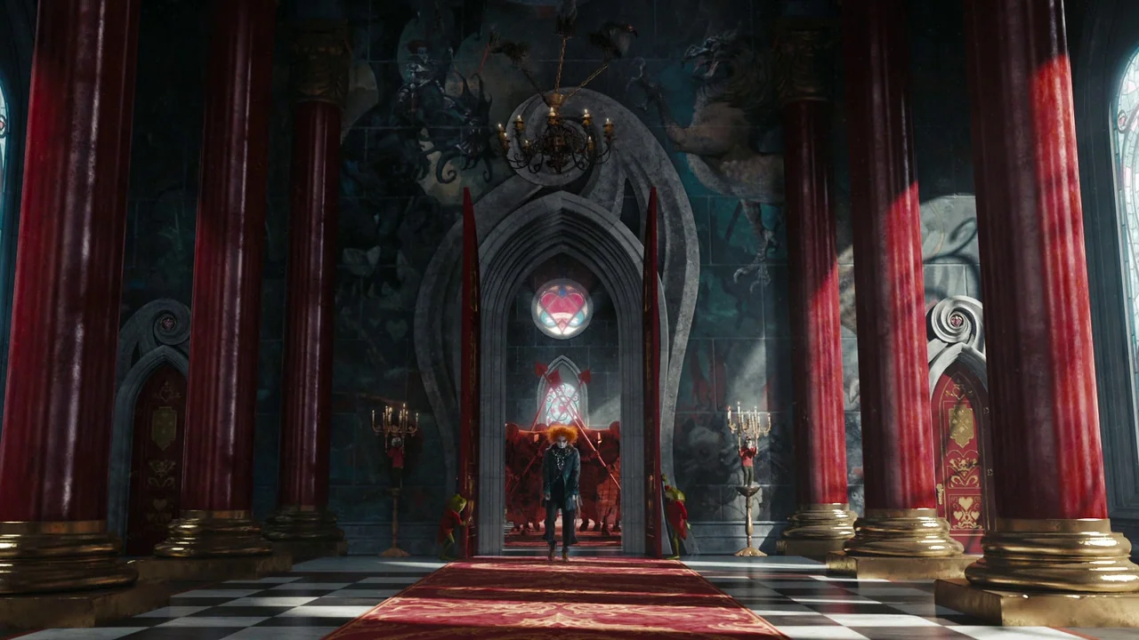 Alice in Wonderland (2010) movie still: wide — A vast hall features towering red columns, a black-and-white tiled floor, and intricate murals. The…