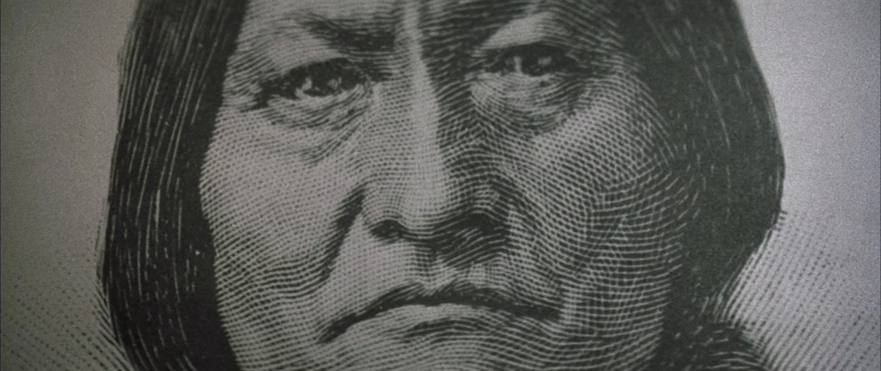 George Washington (2000) movie still: closeup — A close-up view of a printed engraving on a piece of currency. The detailed lines create a portrait…
