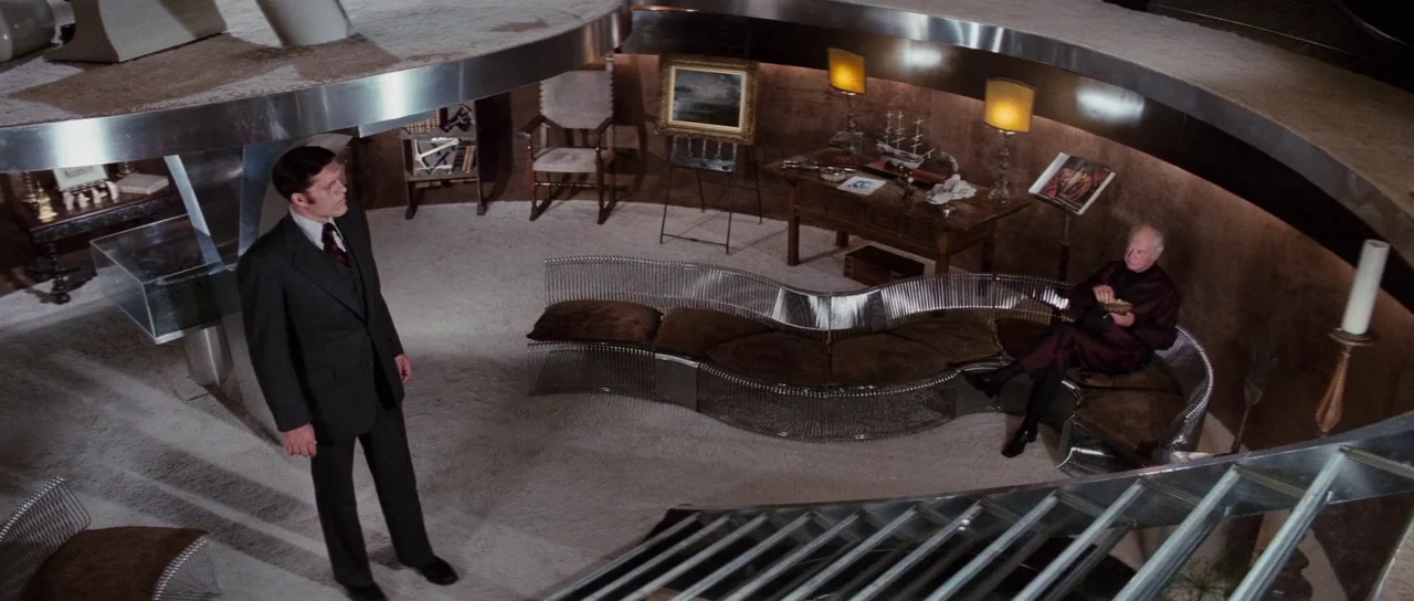 The Spy Who Loved Me (1977) movie still: wide — A spacious sunken living room features a 1970s modern aesthetic with curved chrome furniture. A…