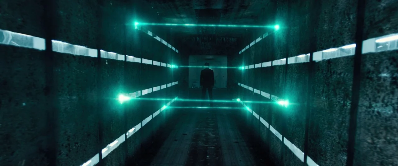Resident Evil: The Final Chapter (2016) movie still: wide — A narrow dark industrial passage features parallel rows of bright glowing green laser…