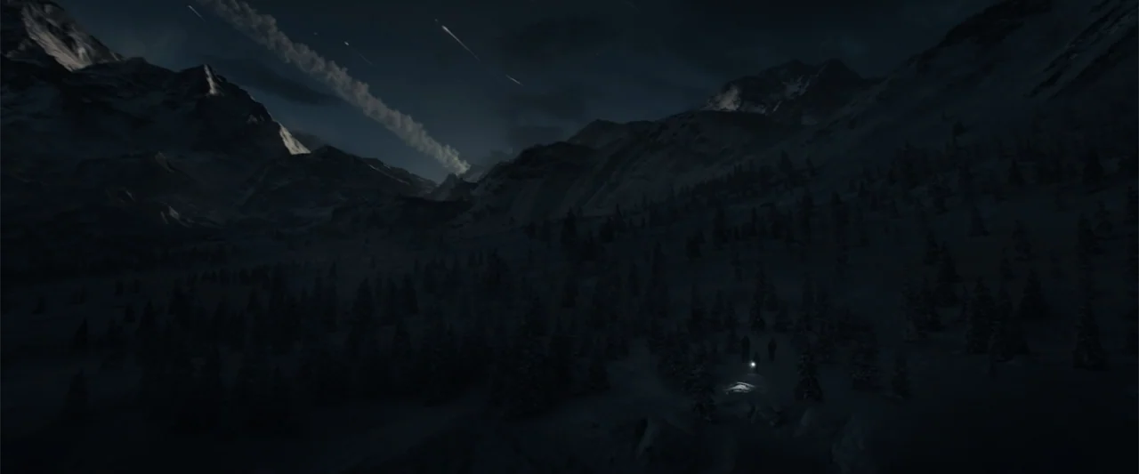 Moonfall (2022) movie still: establishing — A dark mountainous landscape covered in snow under a night sky with meteor streaks. A small beam of…