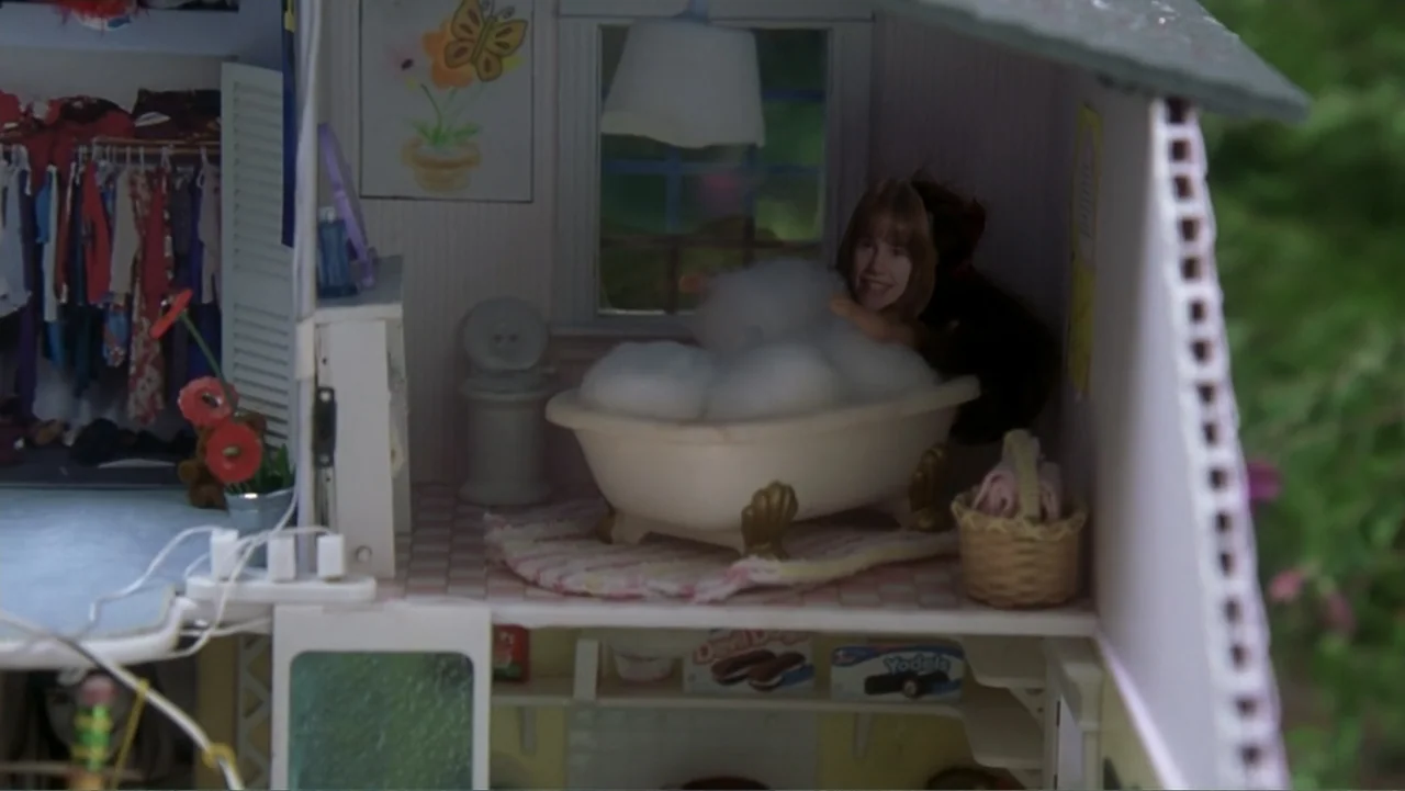 13 Going on 30 (2004) movie still: medium — A detailed dollhouse bathroom features a small white bathtub, a toilet, and a closet. A miniature figure…