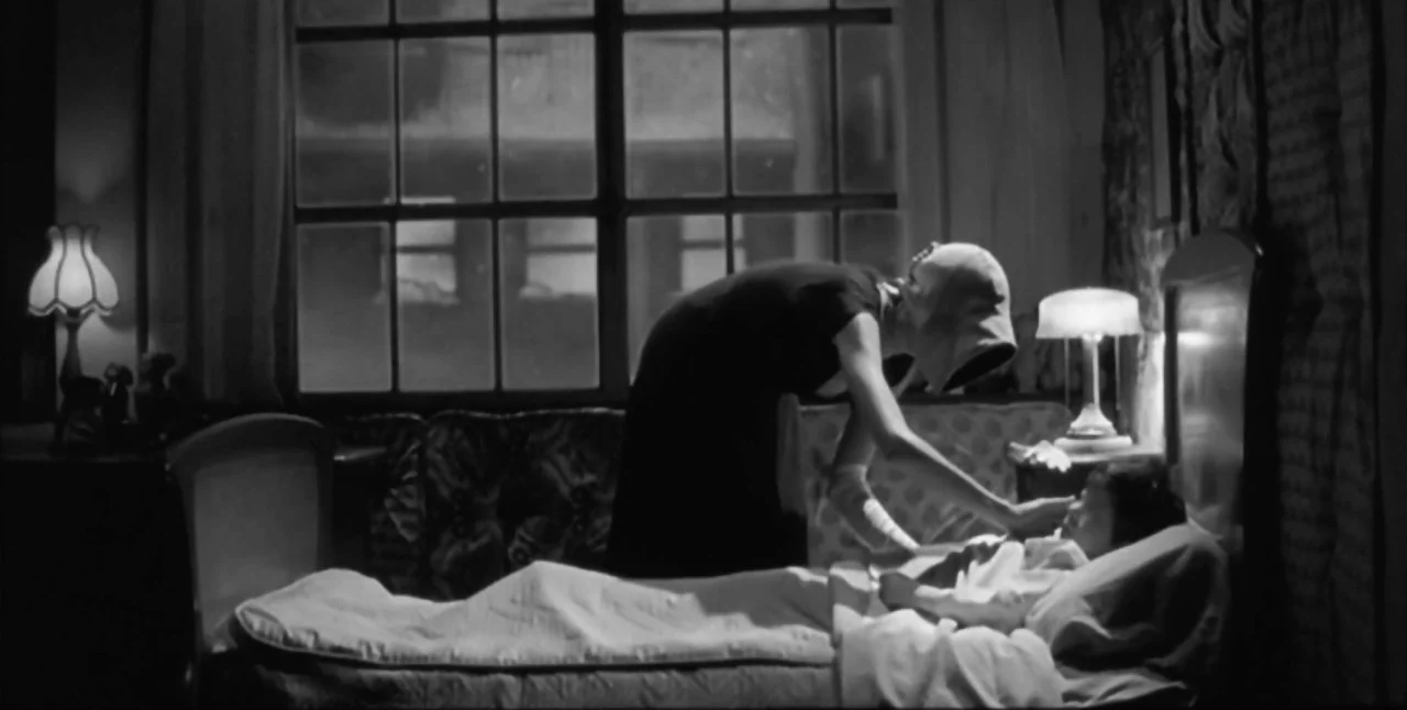 The Aerial (2007) movie still: medium — A dimly lit room at night features a large window behind a bed. A woman in a dark dress leans over the…