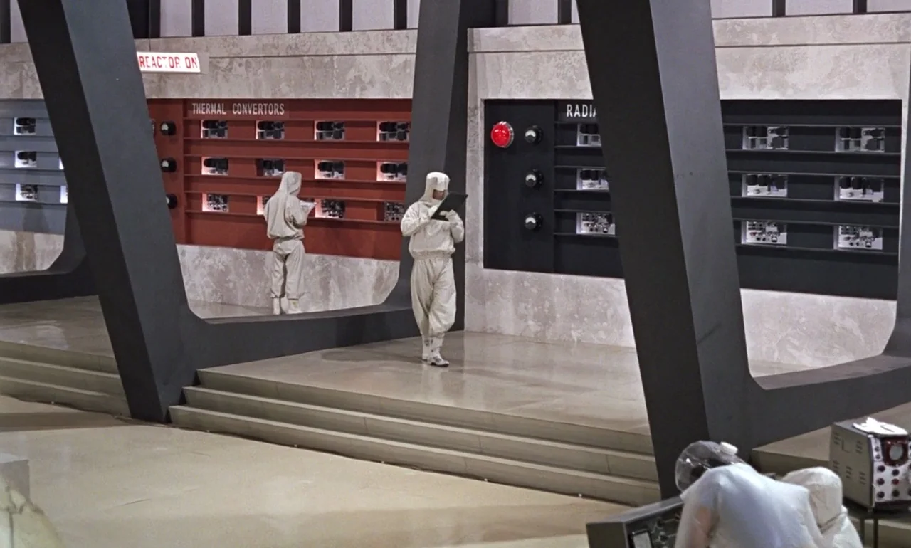 Dr. No (1962) movie still: wide — A spacious laboratory facility features industrial equipment panels labeled Thermal Convertors and Radiators.…