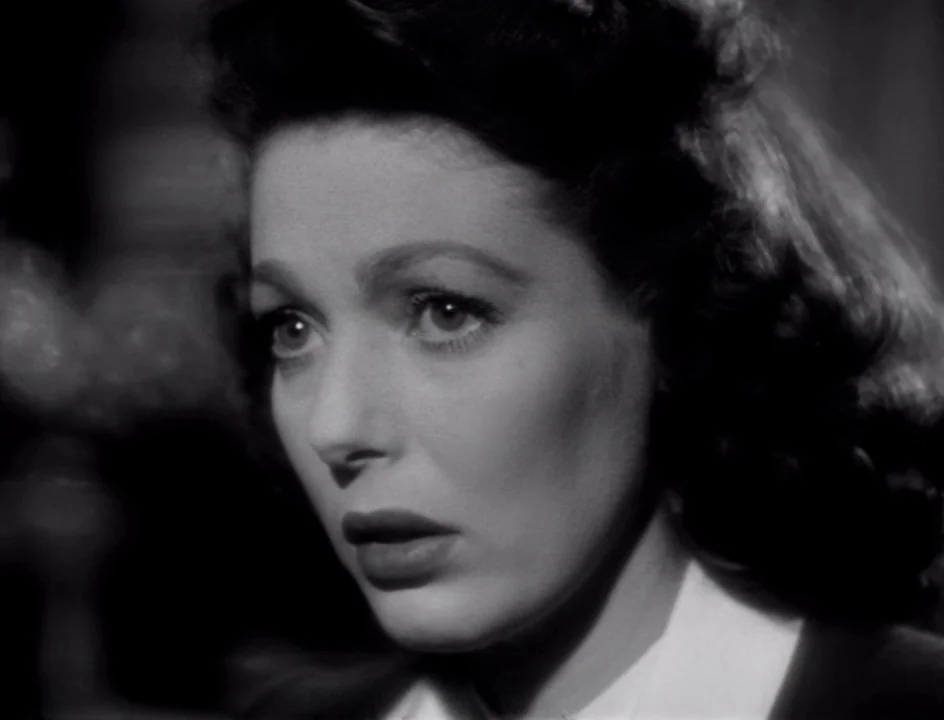 The Stranger (1946) movie still: closeup — An interior space is illuminated by high-contrast lighting typical of film noir. A woman with dark hair…