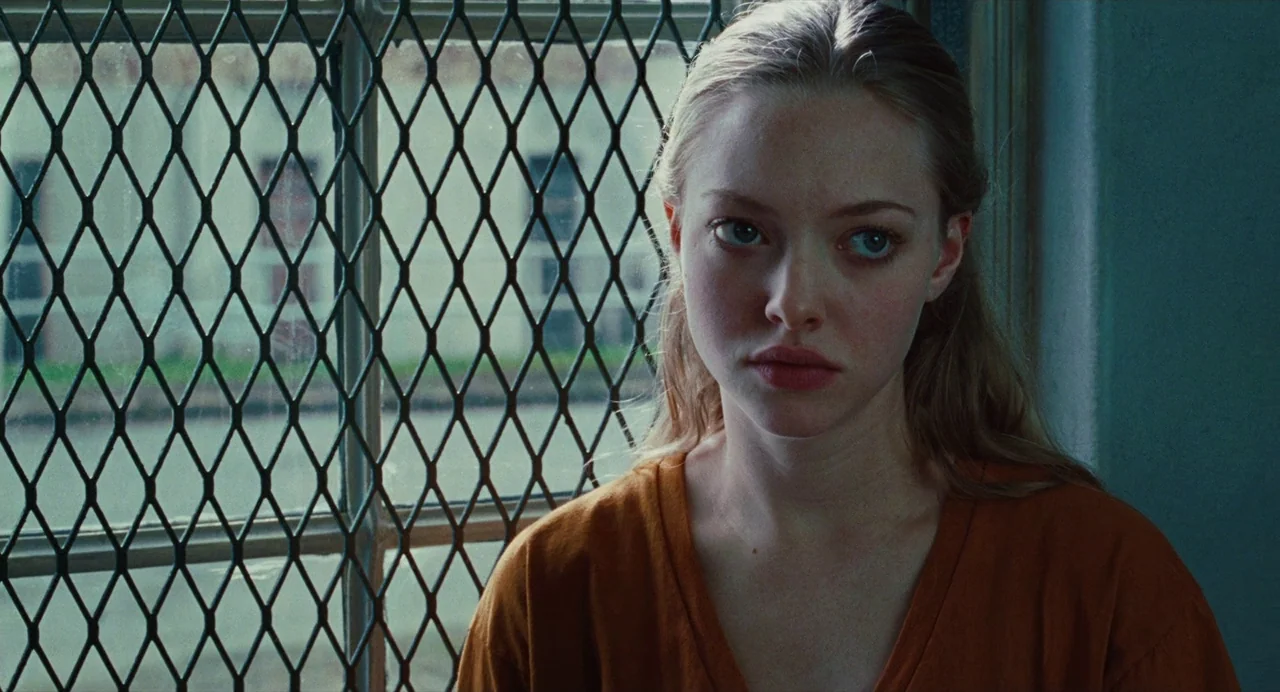Jennifer’s Body (2009) movie still: medium — A pale, cool-toned institutional space features a window covered by a metal security grate. A young…