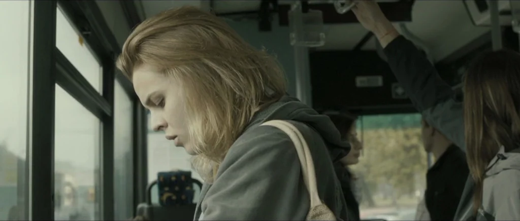 Lasting (Nieulotne) (2013) movie still: medium — A crowded public transit vehicle shows passengers standing along the windows during daytime. A…
