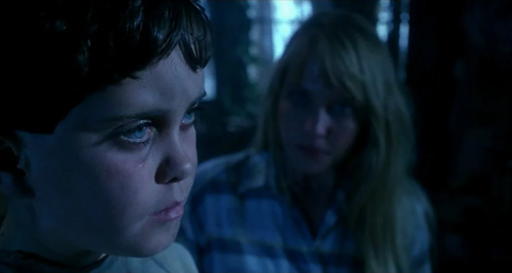 A Nightmare On Elm Street 5: The Dream Child (1989) movie still: closeup — A dimly lit room provides a background for two individuals in close…