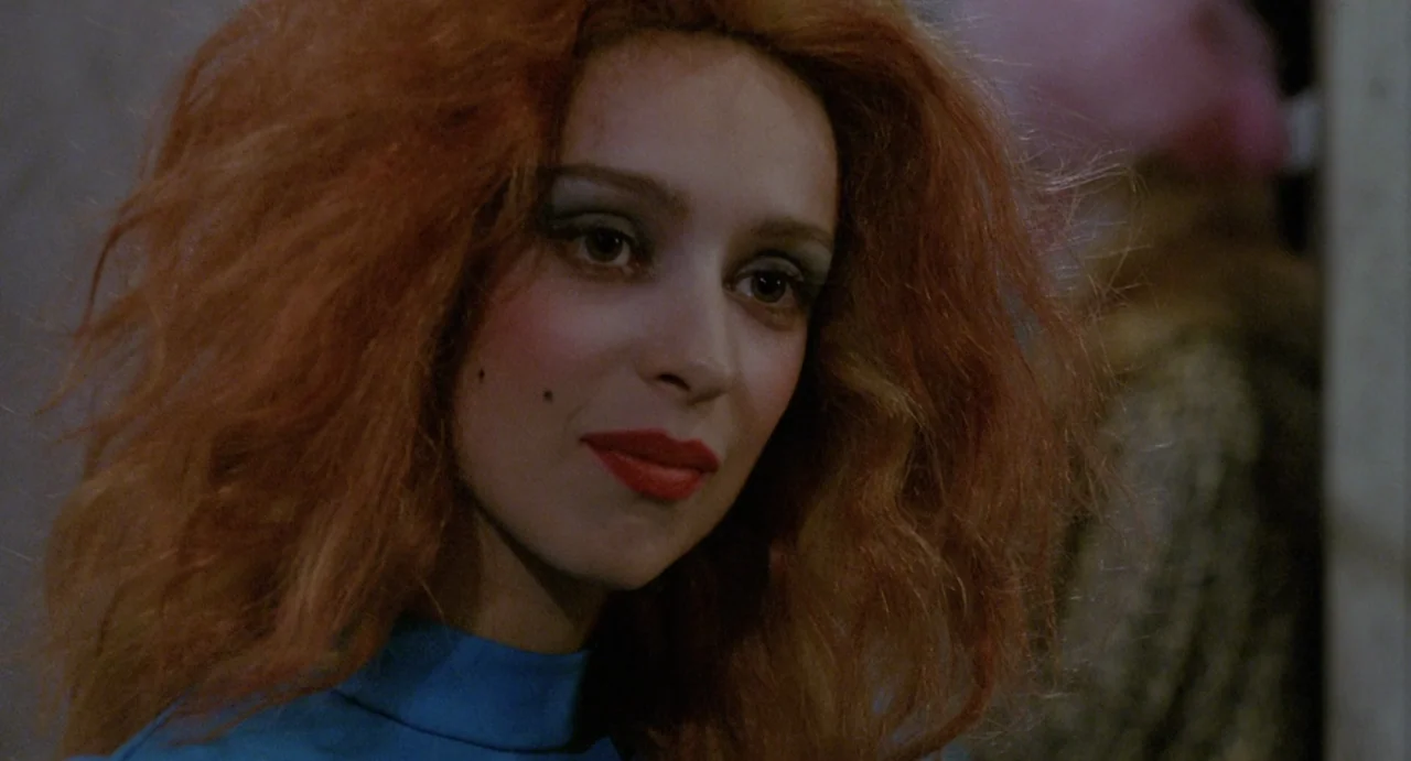 StageFright (1987) movie still: closeup — A close-up shot focuses on a young woman in a dimly lit indoor space. She looks away from the camera with…