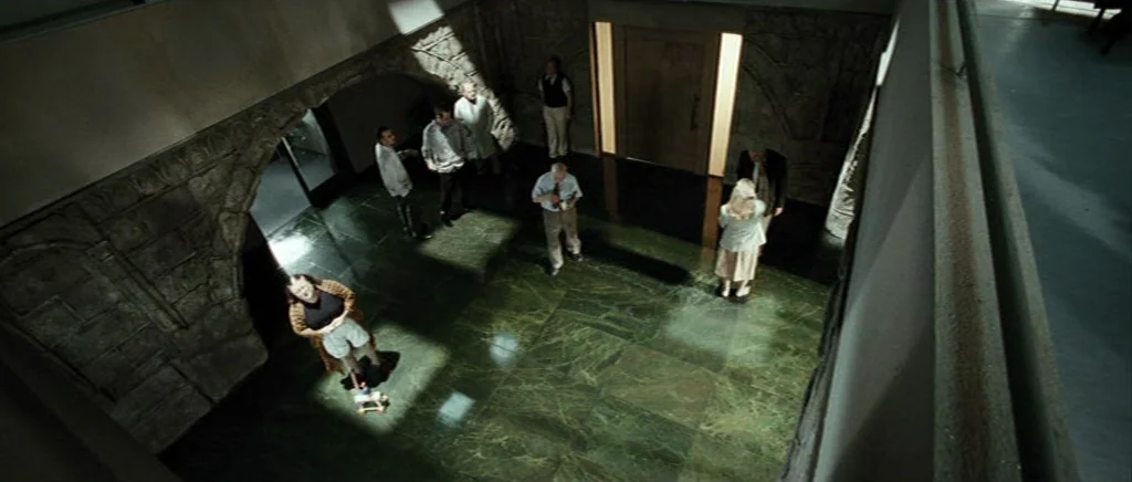 Adam Resurrected (2008) movie still: wide — A spacious atrium features polished dark green marble flooring and stone-textured arched alcoves.…