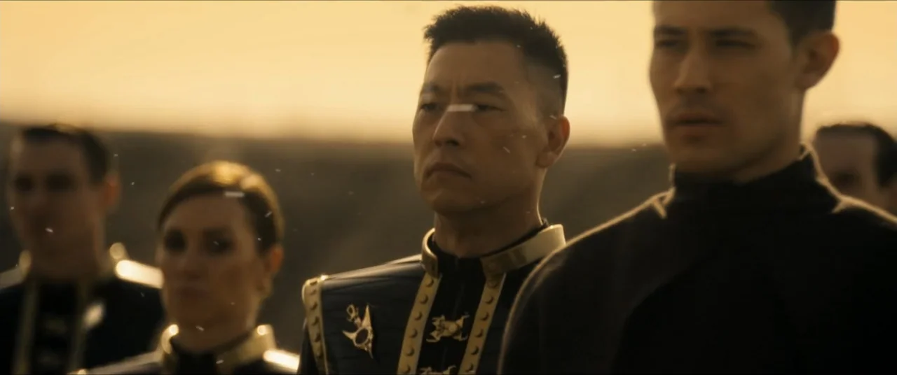 Star Trek: Section 31 (2025) movie still: medium — A group of military personnel stands in formation on a vast, barren sandy landscape. The…