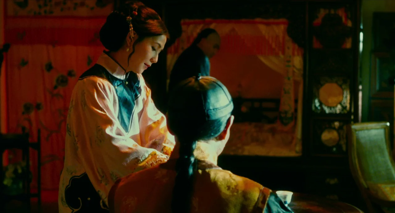 Flowers of Shanghai (1998) movie still: medium — An opulent, dimly lit room features traditional Chinese wooden furniture and draped fabrics. A…