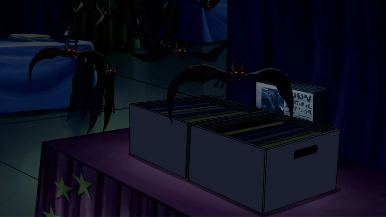 Scooby-Doo! Mask of the Blue Falcon (2012) movie still: medium — An interior display area features storage boxes placed upon a long covered table…