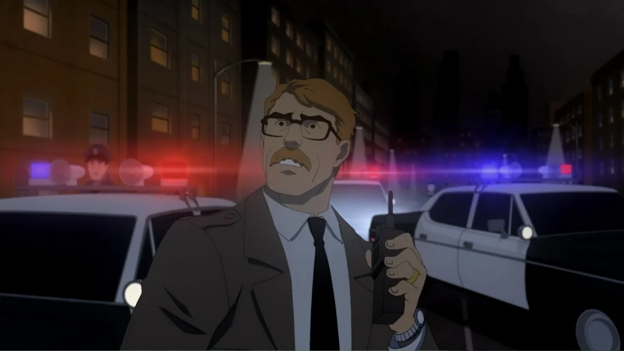 Batman: Year One (2011) movie still: medium — A dark city street at night featuring police cars with activated red and blue sirens. A middle-aged…