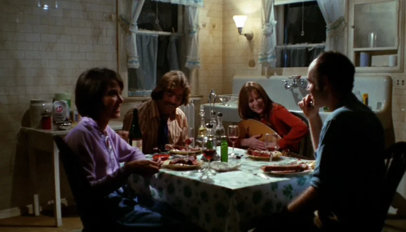 Let’s Scare Jessica To Death (1971) movie still: medium — A 1970s home dining area with white tile walls and a floral patterned tablecloth. Four…