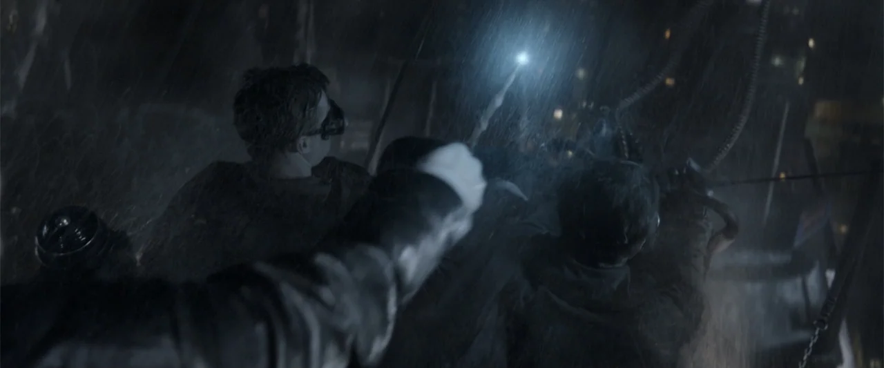 Fantastic Beasts: The Crimes of Grindelwald (2018) movie still: medium — A dark, rainy outdoor environment at night features two individuals in…