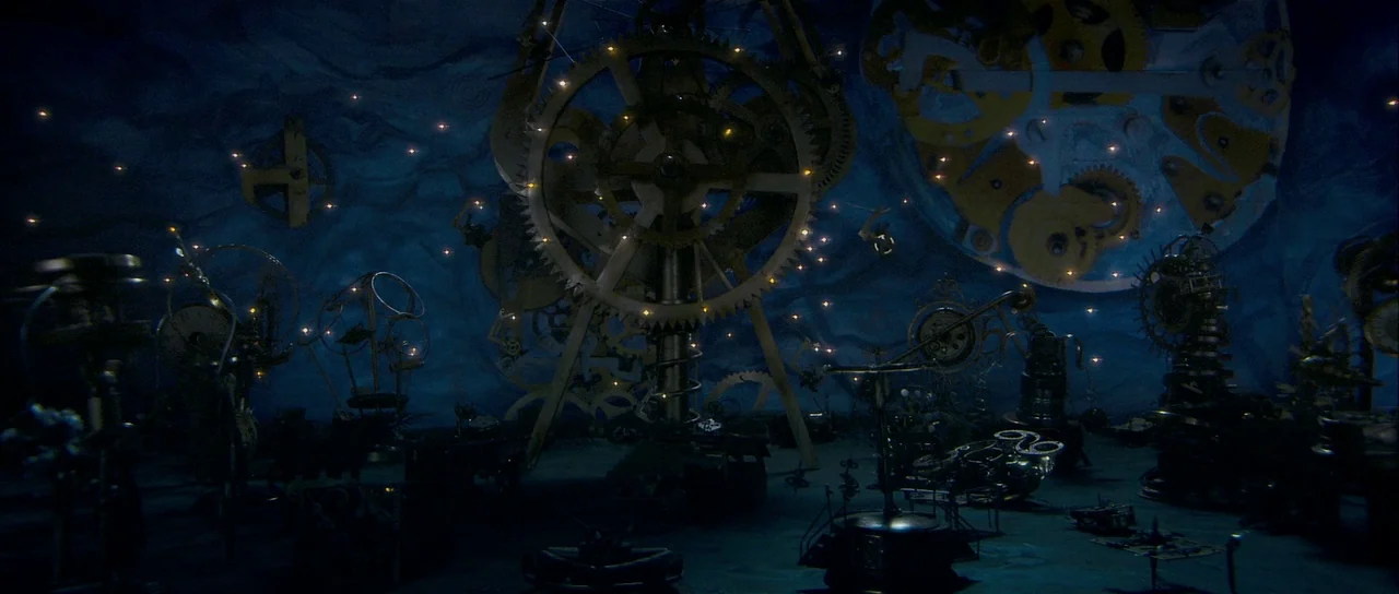 Bunny and the Bull (2009) movie still: establishing — A dark, expansive space filled with oversized brass gears and intricate mechanical components.…