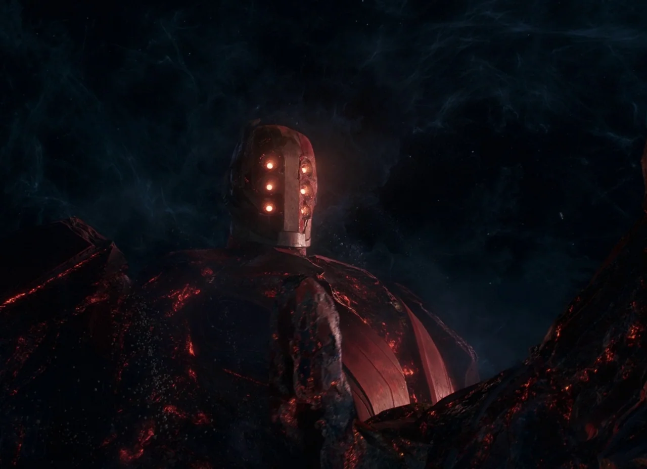 Eternals (2021) movie still: medium — A gigantic celestial entity floats in the dark void of outer space surrounded by gas. The metallic being has…