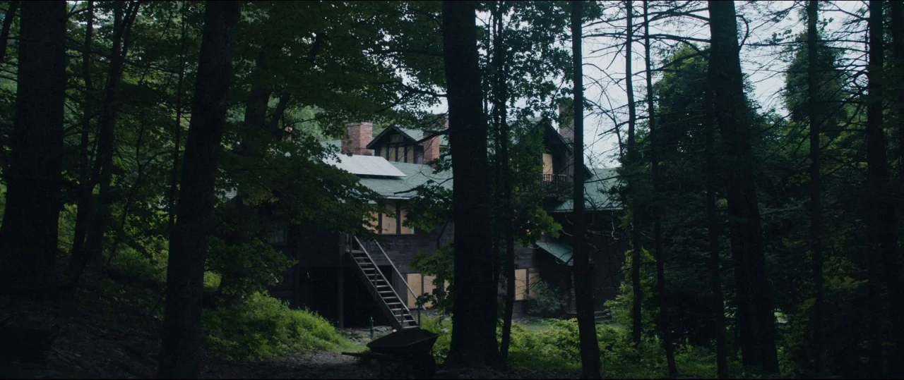 Fall of the House of Usher (1928) movie still: establishing — An abandoned dark-wood house is nestled deep within a thick, overgrown deciduous…