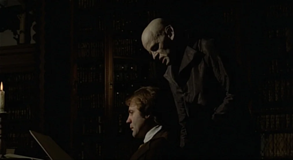 Nosferatu the Vampyre (Nosferatu Phantom Der Nacht) (1979) movie still: medium — A dark study features tall, wood-paneled bookshelves that line the…