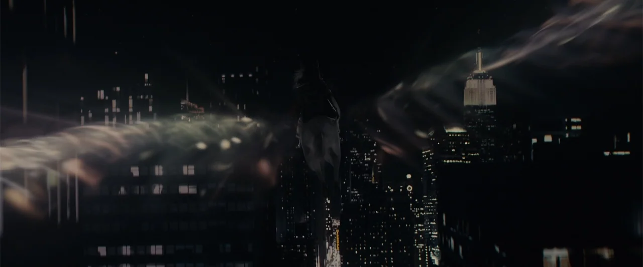 Winter's Tale (2014) movie still: wide — A night view of the New York City skyline with the Empire State Building visible. A rider on a white horse…