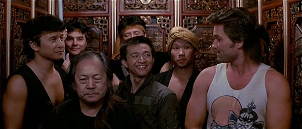 Big Trouble in Little China (1986) movie still: medium — An interior space features ornate, carved wood panels covering the wall surfaces. Several…