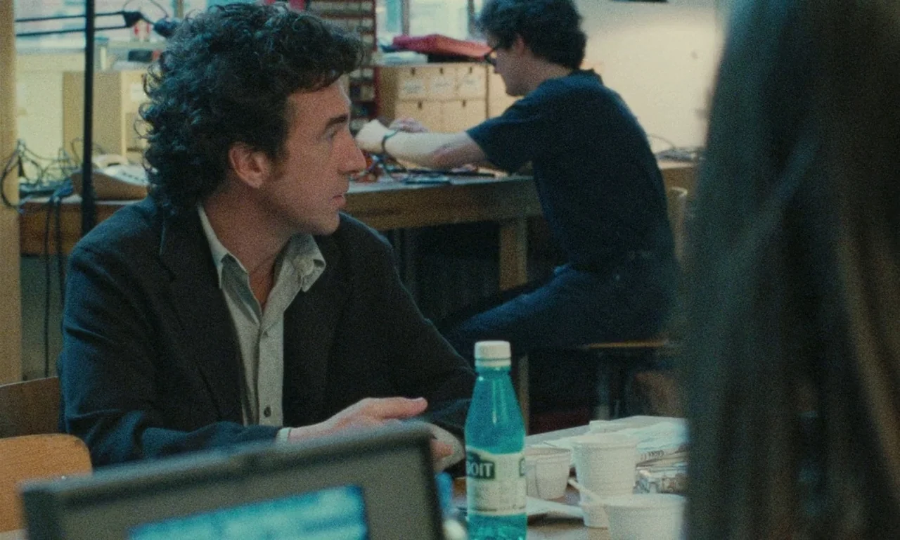 Late August, Early September (1998) movie still: medium — A cluttered workshop space contains wooden tables covered with electronic components and…