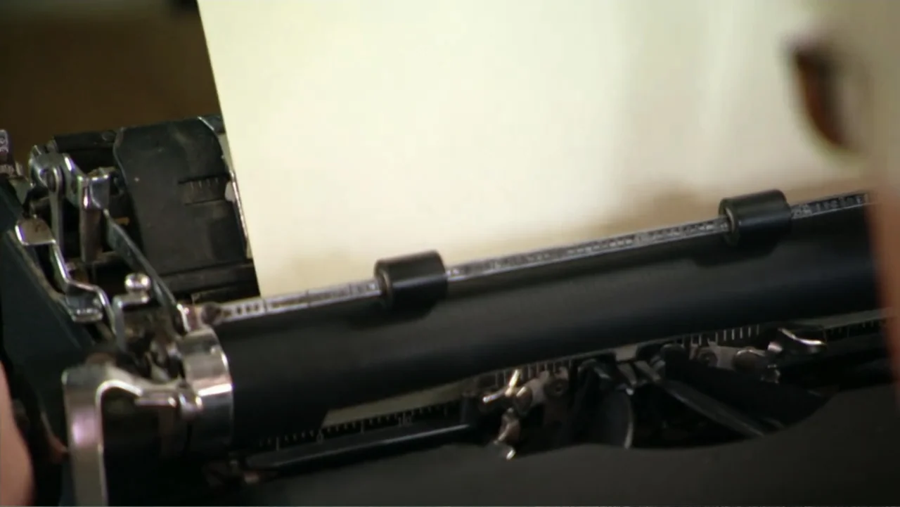 David McCullough: Painting with Words (2008) movie still: closeup — A close-up view shows the metal carriage and rollers of a vintage typewriter. A…