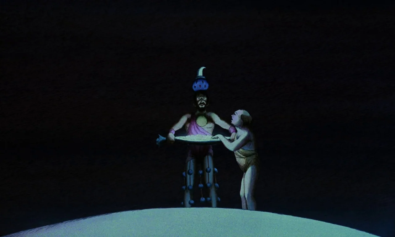 Fantastic Planet (1973) movie still: fullbody — Two animated figures stand upon a pale, rounded hill in deep darkness. The central figure wears…
